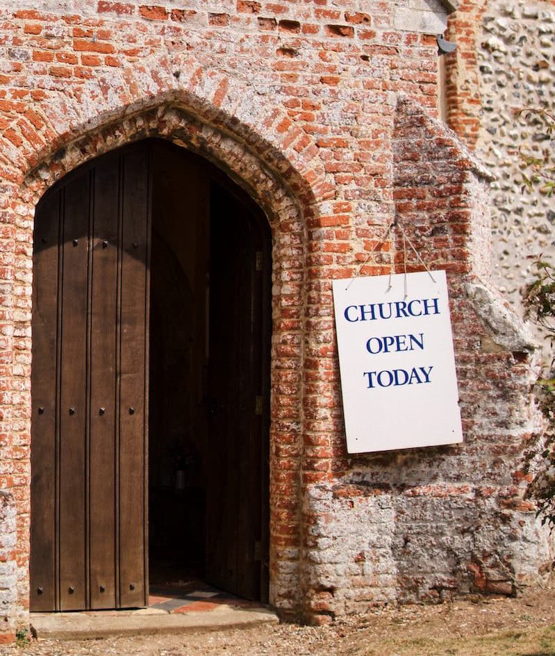 church main entrance with 'church open today' sign