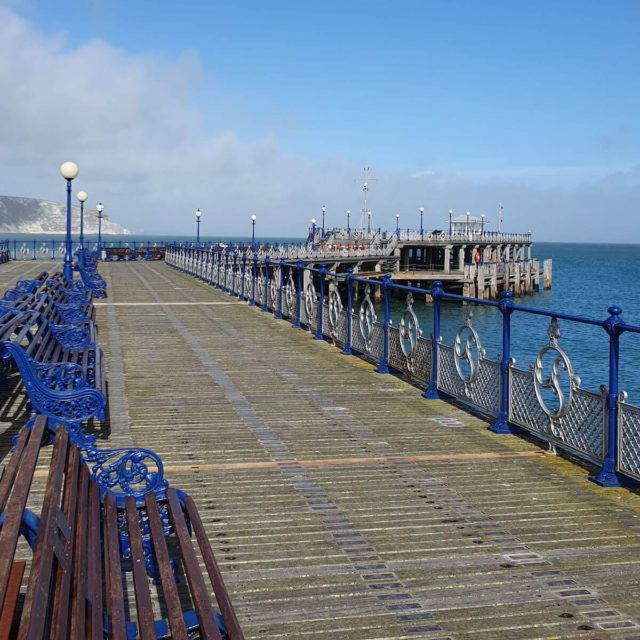 pier boardwalk with benches along the side