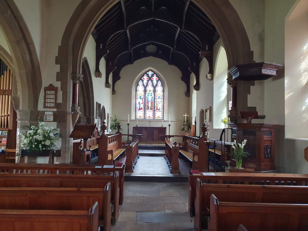 View to altar with stained glass window above